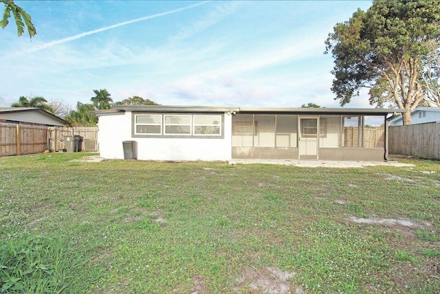 3580 Dunes Rd, Palm Beach Gardens, FL 33410 - back of property with a fenced backyard, stucco siding, and a sunroom