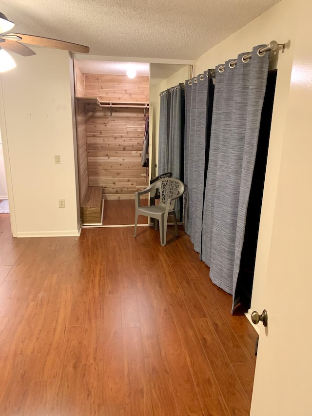 190 Charter Way, West Palm Beach, FL 33407 - unfurnished bedroom with wood finished floors, a textured ceiling, wooden walls, and ceiling fan