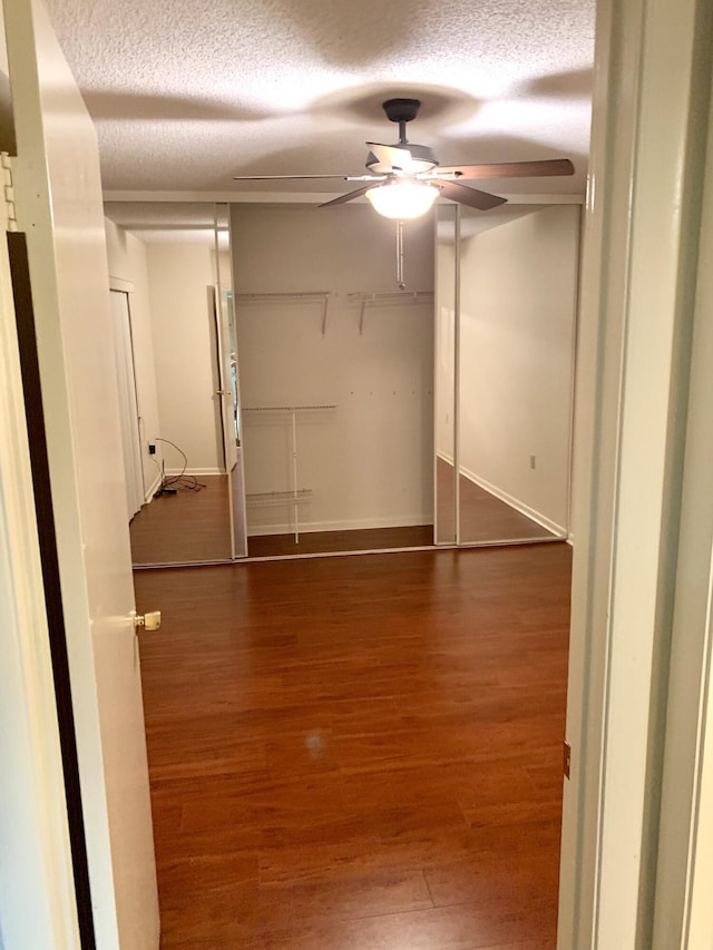 190 Charter Way, West Palm Beach, FL 33407 - unfurnished bedroom with a textured ceiling, wood finished floors, and ceiling fan
