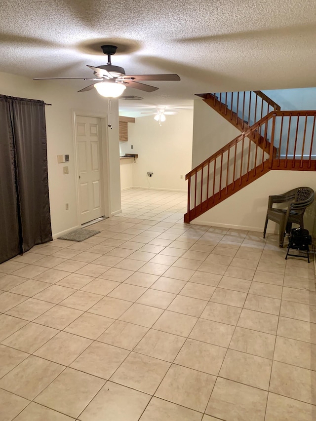 190 Charter Way, West Palm Beach, FL 33407 - unfurnished living room with a textured ceiling, a ceiling fan, stairs, and light tile patterned floors