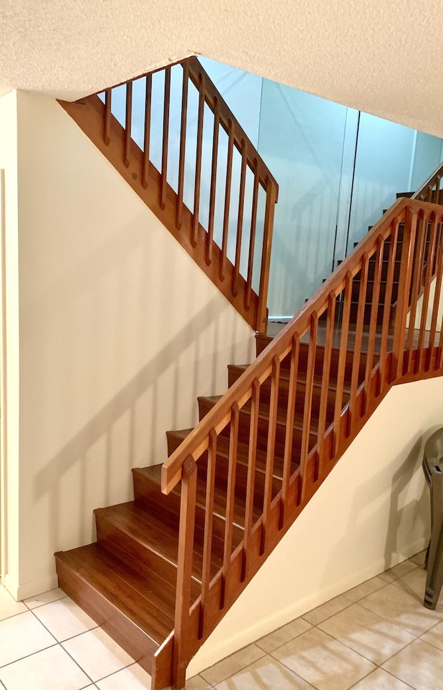 190 Charter Way, West Palm Beach, FL 33407 - stairway featuring tile patterned floors and a textured ceiling