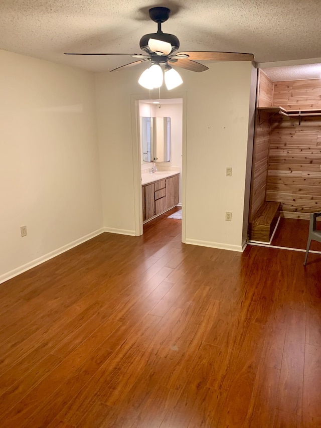 190 Charter Way, West Palm Beach, FL 33407 - unfurnished bedroom with dark wood-style flooring, a textured ceiling, and ceiling fan