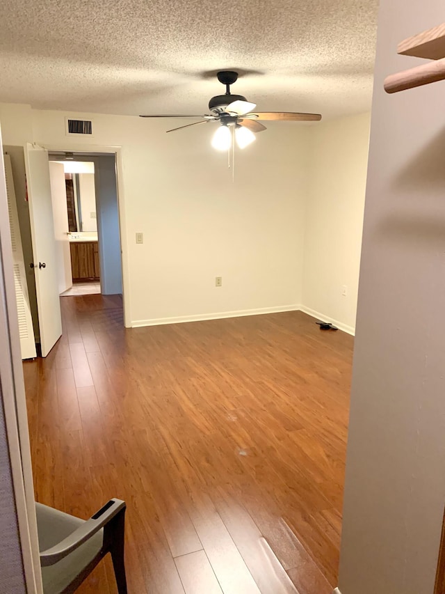 190 Charter Way, West Palm Beach, FL 33407 - empty room featuring a ceiling fan, a textured ceiling, and dark wood-type flooring