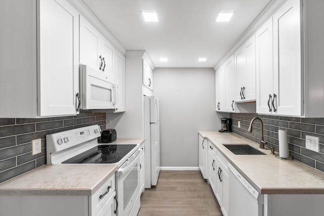 2054 Cornwall C, Boca Raton, FL 33434 - kitchen with white appliances, decorative backsplash, light wood finished floors, and white cabinets