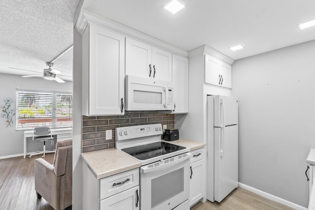 2054 Cornwall C, Boca Raton, FL 33434 - kitchen featuring white appliances, light wood-type flooring, light countertops, tasteful backsplash, and white cabinetry