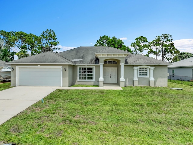 3601 SW Europe St, Port Saint Lucie, FL 34953 - view of front of home featuring an attached garage, stucco siding, concrete driveway, and a front lawn