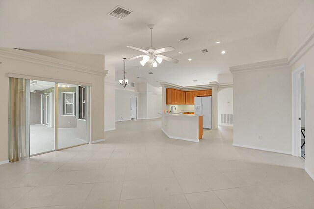3601 SW Europe St, Port Saint Lucie, FL 34953 - kitchen with white refrigerator with ice dispenser, open floor plan, ceiling fan, lofted ceiling, and brown cabinets