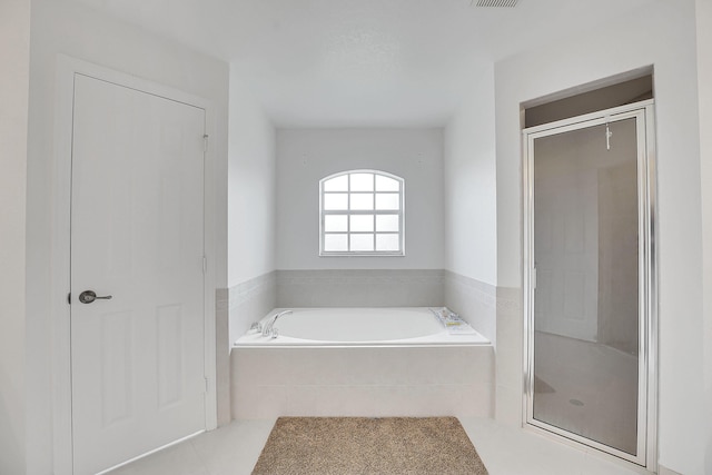 3601 SW Europe St, Port Saint Lucie, FL 34953 - bathroom featuring a garden tub, a shower stall, and tile patterned flooring