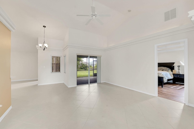 3601 SW Europe St, Port Saint Lucie, FL 34953 - empty room with a chandelier, ceiling fan, light tile patterned floors, and high vaulted ceiling