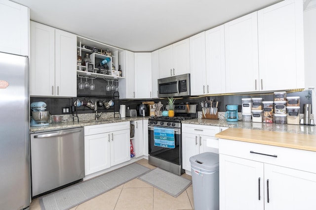 2140 White Pine Cir Unit A, Greenacres, FL 33415 - kitchen with appliances with stainless steel finishes, light tile patterned floors, and white cabinetry