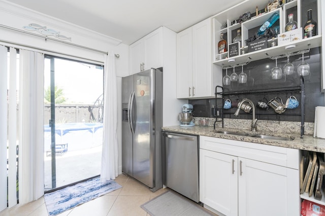 2140 White Pine Cir Unit A, Greenacres, FL 33415 - kitchen with stainless steel appliances, light tile patterned floors, light stone counters, white cabinetry, and ornamental molding