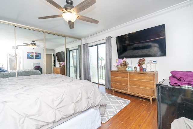 2140 White Pine Cir Unit A, Greenacres, FL 33415 - bedroom with ornamental molding, access to exterior, wood finished floors, a closet, and a ceiling fan
