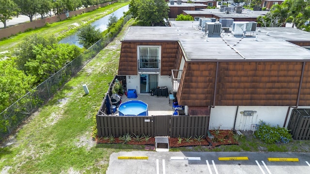 2140 White Pine Cir Unit A, Greenacres, FL 33415 - back of property featuring a fenced backyard, uncovered parking, a patio, and a balcony