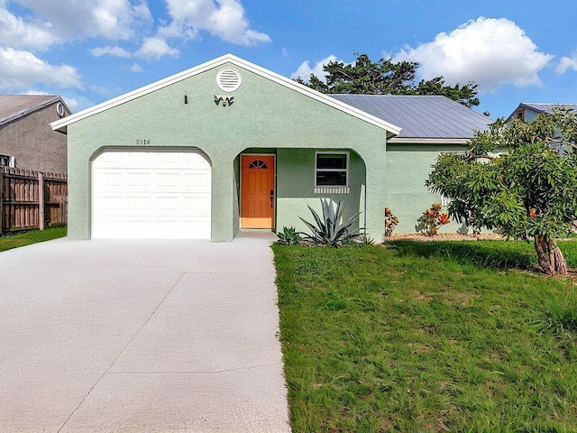 5914 SE Mitzi Ln, Stuart, FL 34997 - view of front of property with concrete driveway, stucco siding, and a garage