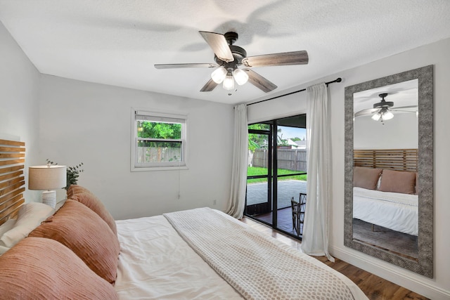 5914 SE Mitzi Ln, Stuart, FL 34997 - bedroom featuring access to outside, wood finished floors, and a ceiling fan