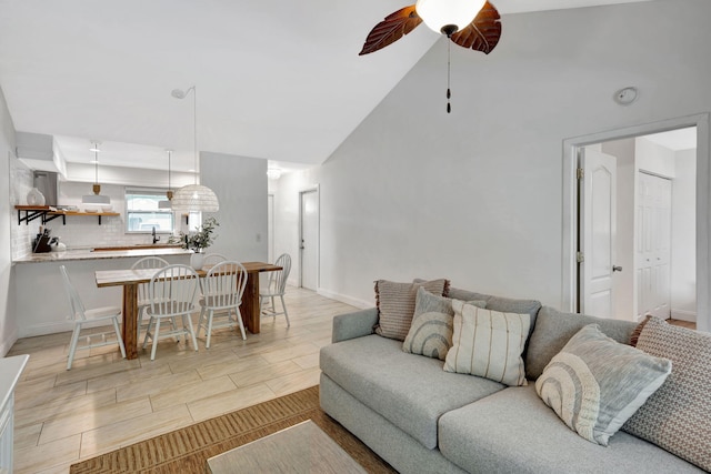 5914 SE Mitzi Ln, Stuart, FL 34997 - living area featuring ceiling fan, vaulted ceiling, and wood tiled floors