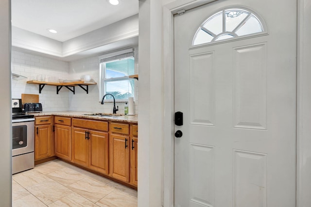 5914 SE Mitzi Ln, Stuart, FL 34997 - kitchen featuring stainless steel electric range, light stone countertops, decorative backsplash, brown cabinetry, and light marble finish flooring