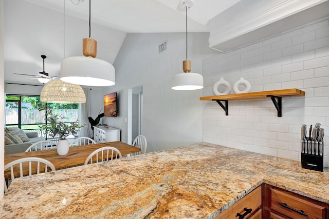 5914 SE Mitzi Ln, Stuart, FL 34997 - kitchen featuring open shelves, light stone counters, a ceiling fan, decorative backsplash, and hanging light fixtures
