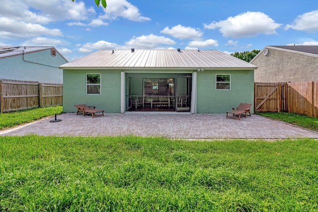 5914 SE Mitzi Ln, Stuart, FL 34997 - rear view of house featuring stucco siding, a fenced backyard, and a patio area