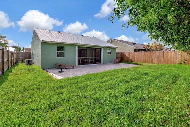 5914 SE Mitzi Ln, Stuart, FL 34997 - rear view of house with stucco siding, a patio, a fenced backyard, and a metal roof