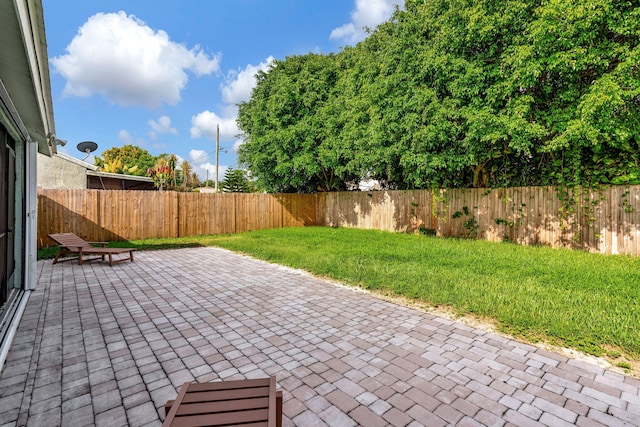 5914 SE Mitzi Ln, Stuart, FL 34997 - fenced backyard featuring a patio area