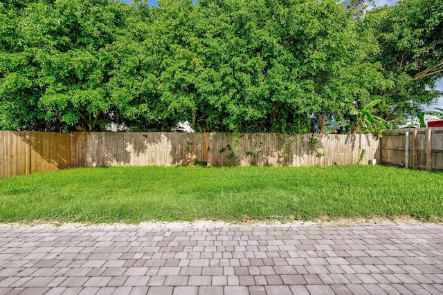 5914 SE Mitzi Ln, Stuart, FL 34997 - fenced backyard with a patio