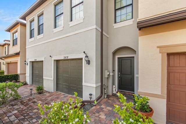 2418 Post St, Palm Springs, FL 33406 - view of front of home with stucco siding and a garage