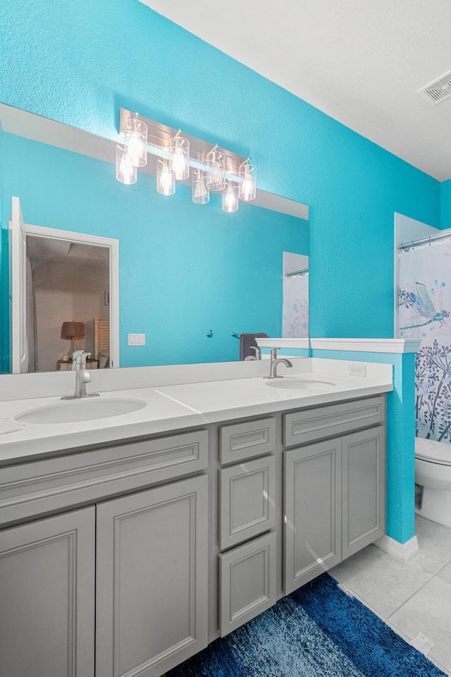 2418 Post St, Palm Springs, FL 33406 - bathroom featuring double vanity, tile patterned flooring, a textured wall, and curtained shower