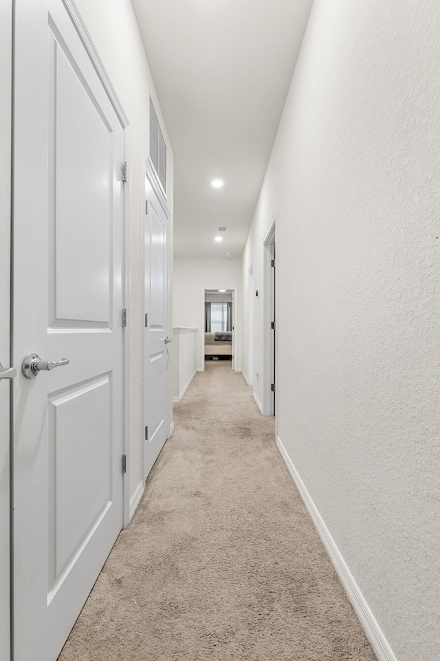 2418 Post St, Palm Springs, FL 33406 - hallway with light carpet and baseboards