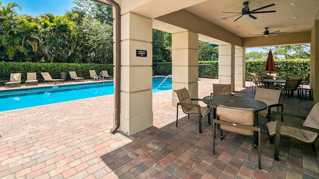 2418 Post St, Palm Springs, FL 33406 - community pool with outdoor dining area, a patio, and ceiling fan