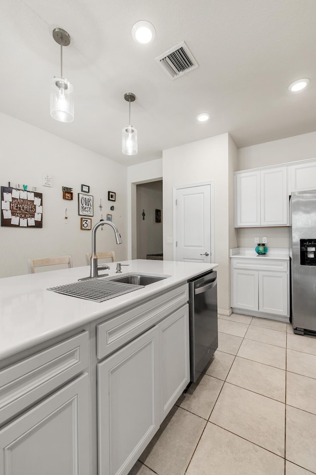 2418 Post St, Palm Springs, FL 33406 - kitchen featuring appliances with stainless steel finishes, white cabinetry, pendant lighting, recessed lighting, and light countertops