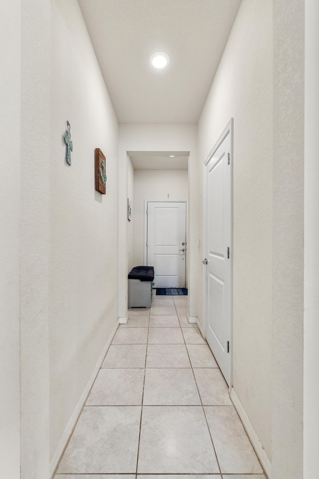 2418 Post St, Palm Springs, FL 33406 - hallway with light tile patterned floors and baseboards