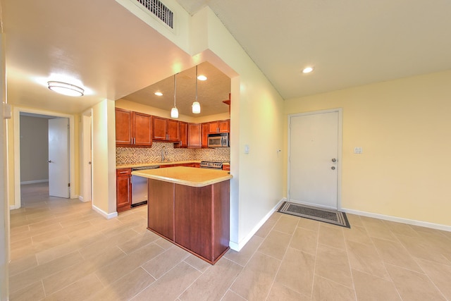 2050 Oleander Blvd Unit 5301, Fort Pierce, FL 34950 - kitchen featuring stainless steel appliances, light countertops, backsplash, brown cabinets, and decorative light fixtures