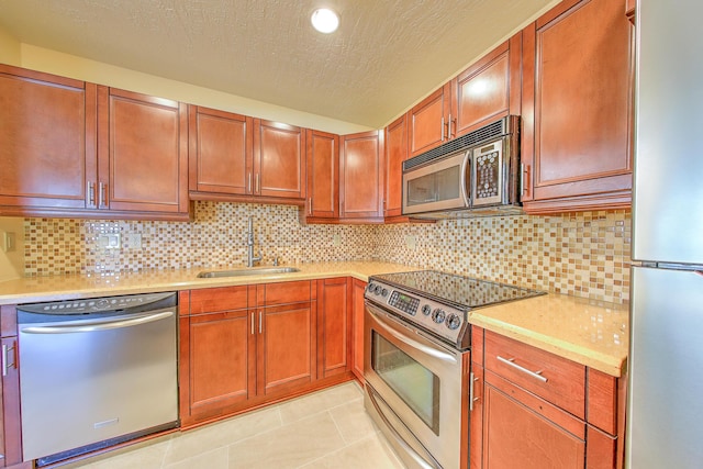2050 Oleander Blvd Unit 5301, Fort Pierce, FL 34950 - kitchen with stainless steel appliances, light countertops, light tile patterned floors, and a textured ceiling