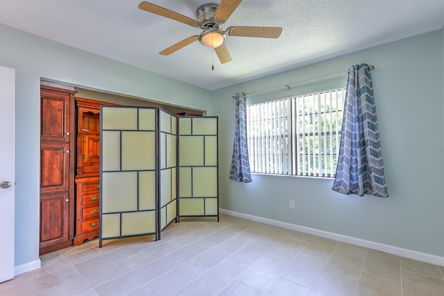 2050 Oleander Blvd Unit 5301, Fort Pierce, FL 34950 - unfurnished bedroom featuring light tile patterned floors, a textured ceiling, and a ceiling fan