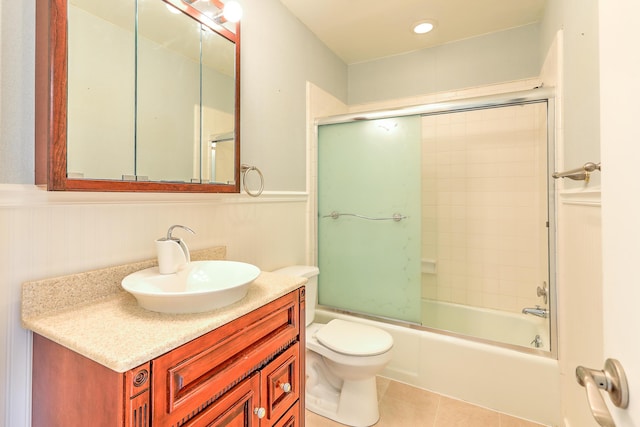 2050 Oleander Blvd Unit 5301, Fort Pierce, FL 34950 - bathroom with tile patterned floors, vanity, wainscoting, and bath / shower combo with glass door
