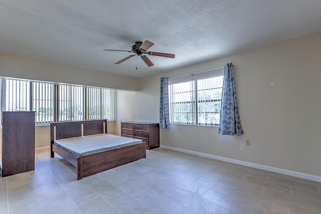 2050 Oleander Blvd Unit 5301, Fort Pierce, FL 34950 - bedroom with a textured ceiling, a ceiling fan, and light tile patterned flooring