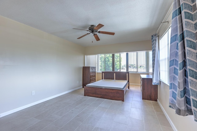 2050 Oleander Blvd Unit 5301, Fort Pierce, FL 34950 - bedroom featuring a textured ceiling, light tile patterned flooring, and a ceiling fan