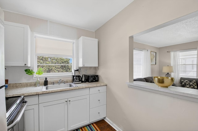 363 Sheffield O, West Palm Beach, FL 33417 - kitchen featuring stainless steel range oven, light countertops, white cabinetry, decorative backsplash, and dark wood-type flooring
