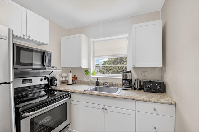 363 Sheffield O, West Palm Beach, FL 33417 - kitchen with stainless steel appliances, decorative backsplash, white cabinets, and light countertops