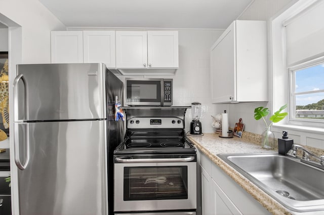 363 Sheffield O, West Palm Beach, FL 33417 - kitchen with stainless steel appliances, tasteful backsplash, white cabinetry, and light countertops