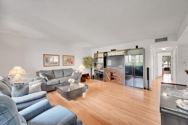 15126 Ashland St Unit 250, Delray Beach, FL 33484 - living room with light wood-type flooring and a textured ceiling