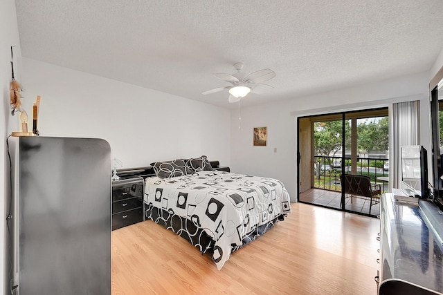 15126 Ashland St Unit 250, Delray Beach, FL 33484 - bedroom featuring light wood finished floors, access to exterior, freestanding refrigerator, a textured ceiling, and ceiling fan