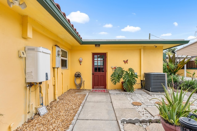 1802 Lake Osborne Dr, Lake Worth Beach, FL 33461 - doorway to property with stucco siding and water heater