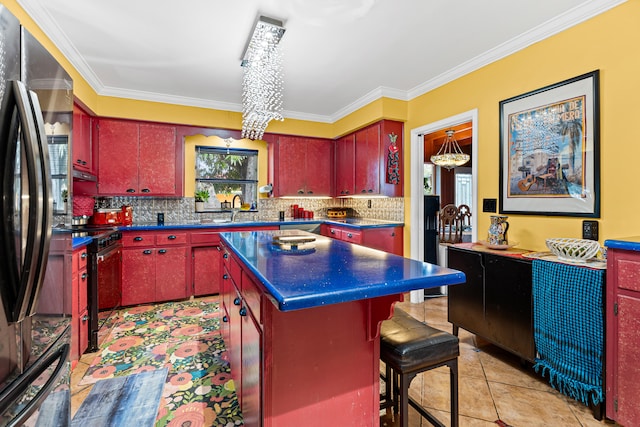 1802 Lake Osborne Dr, Lake Worth Beach, FL 33461 - kitchen featuring freestanding refrigerator, red cabinets, backsplash, crown molding, and dark countertops
