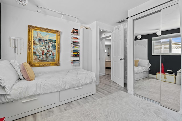 1802 Lake Osborne Dr, Lake Worth Beach, FL 33461 - bedroom featuring wood finished floors, track lighting, and a closet