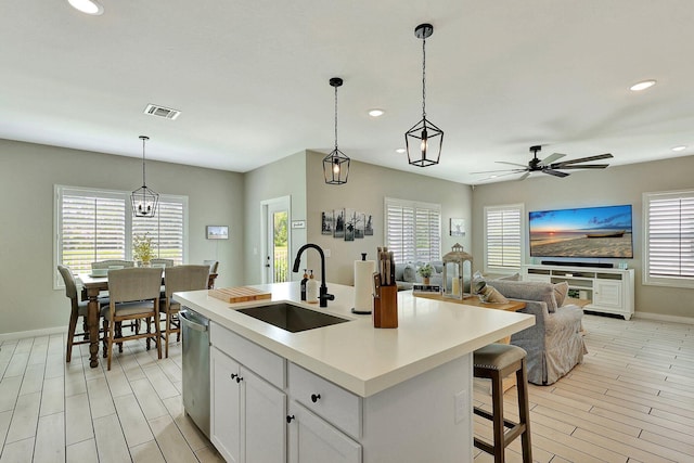 650 NE Waters Edge Ln, Port Saint Lucie, FL 34983 - kitchen with dishwasher, recessed lighting, ceiling fan, open floor plan, and white cabinets
