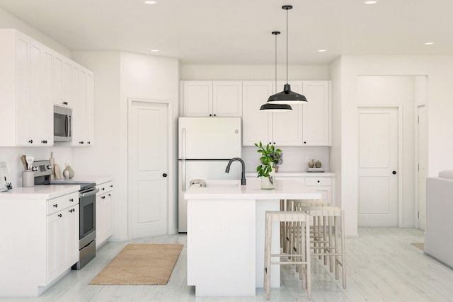 650 NE Waters Edge Ln, Port Saint Lucie, FL 34983 - kitchen featuring appliances with stainless steel finishes, recessed lighting, pendant lighting, and white cabinetry