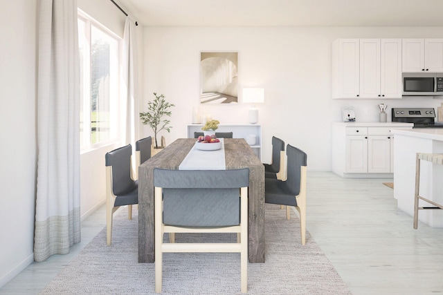 650 NE Waters Edge Ln, Port Saint Lucie, FL 34983 - dining area featuring light wood-style floors and baseboards