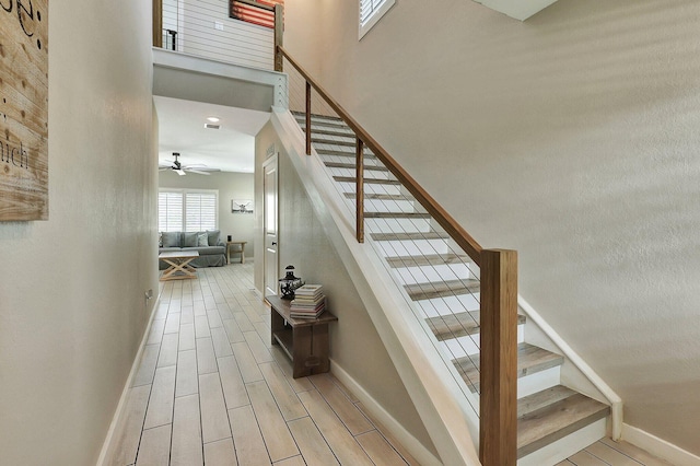 650 NE Waters Edge Ln, Port Saint Lucie, FL 34983 - stairway with ceiling fan, wood tiled floors, and a high ceiling